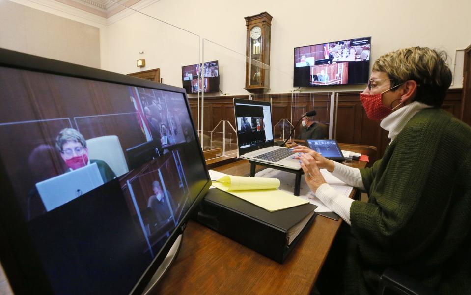 Summit County Common Pleas Judge Tammy O'Brien demonstrates the new technology in her courtroom in March 2022.