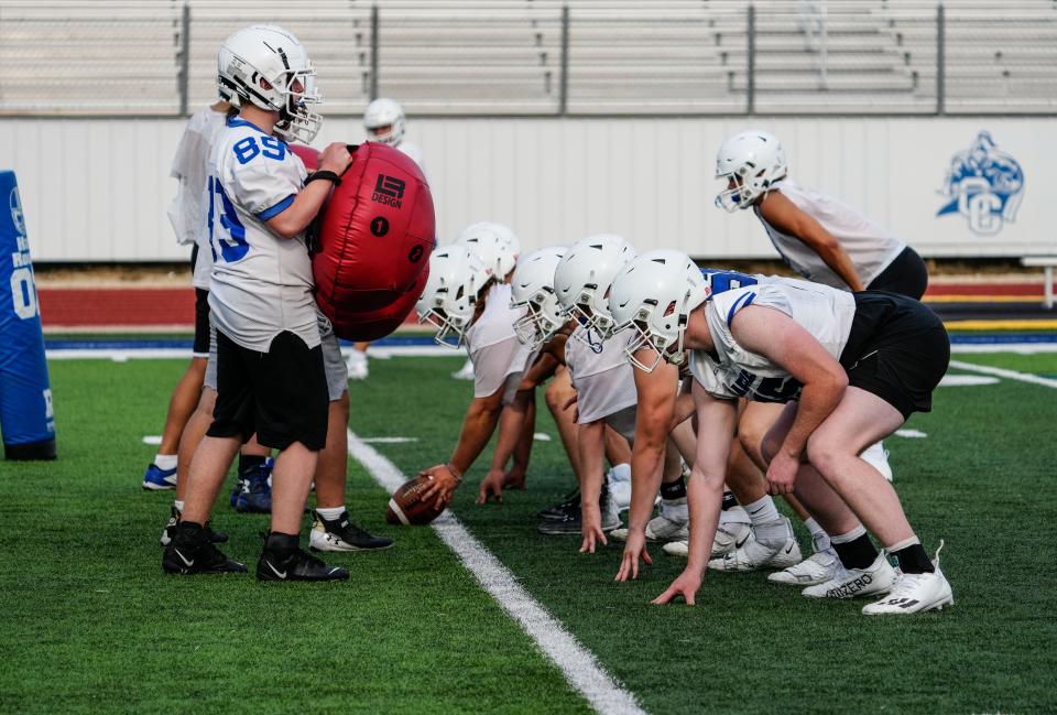 Oak Creek players run a drill during high school football practice on Wednesday, August 2, 2023.