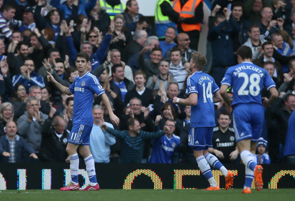 Chelsea's Oscar celebrates after scoring his side's 5th goal during their English Premier League soccer match between Chelsea and Arsenal at Stamford Bridge stadium in London, Saturday, March, 22, 2014. (AP Photo/Alastair Grant)