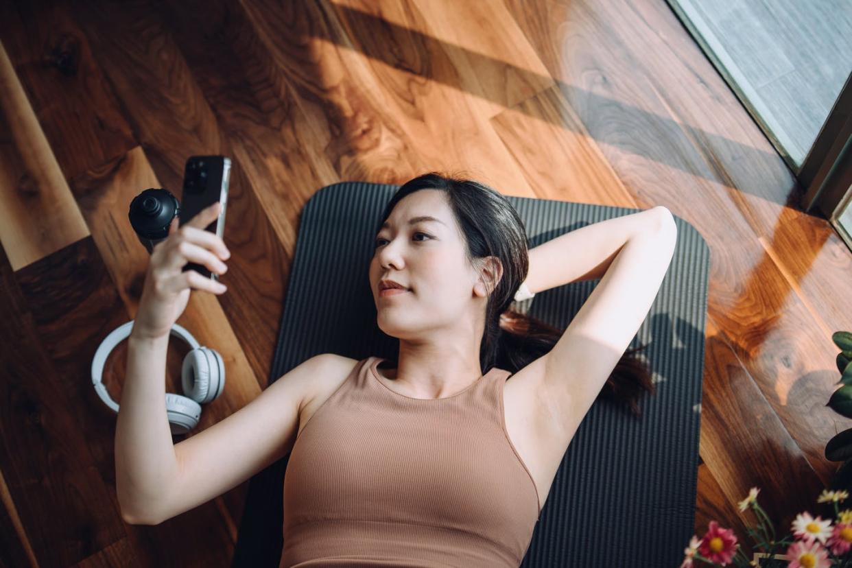 <span class="caption">More and more people are experimenting with mental health apps and discovering their benefits and limits.</span> <span class="attribution"><a class="link " href="https://www.gettyimages.com/detail/photo/high-angle-shot-of-fitness-young-asian-sports-woman-royalty-free-image/1396029512?adppopup=true" rel="nofollow noopener" target="_blank" data-ylk="slk:d3sign/Moment via Getty Images;elm:context_link;itc:0;sec:content-canvas">d3sign/Moment via Getty Images</a></span>