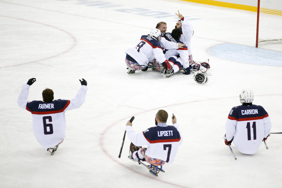 United States players celebrate as they win the gold medal after their ice sledge hockey match against Russia at the 2014 Winter Paralympics in Sochi, Russia, Saturday, March 15, 2014. United States won 1-0. (AP Photo/Pavel Golovkin)