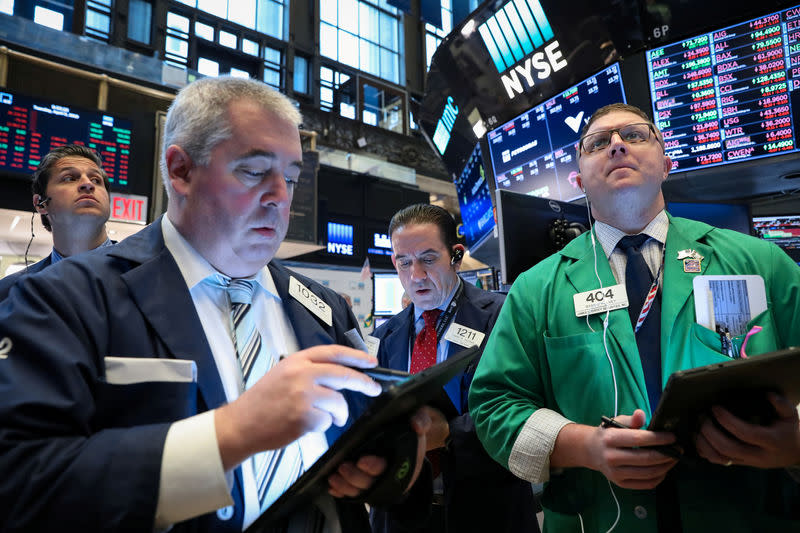 FILE PHOTO: Traders work on the floor at the New York Stock Exchange (NYSE) in New York, U.S., April 9, 2019. REUTERS/Brendan McDermid