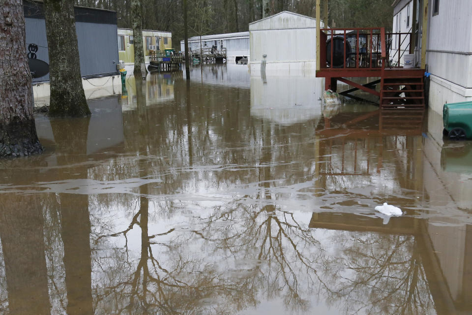 Standing floodwater from the Pearl River surrounds a number of mobile homes in the Harbor Pines community in Ridgeland, Miss., Tuesday, Feb. 18, 2020. While much of the water in the community receded overnight, there are areas that still have high water. (AP Photo/Rogelio V. Solis)