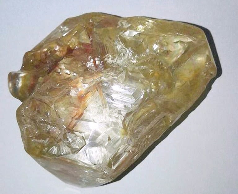 "God don bless we tiday," one of preacher Emmanuel Momoh's workers in Sierra Leone shouted brandishing a honey-coloured rock which turned out to be a 706-carat diamond