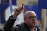 A demonstrator holds a crucifix during a protest outside the Portuguese parliament in Lisbon, Thursday, Feb. 20, 2020. Protesters gathered Thursday outside Portugal's where lawmakers were due to debate proposals that would allow euthanasia and doctor-assisted suicide. (AP Photo/Armando Franca)