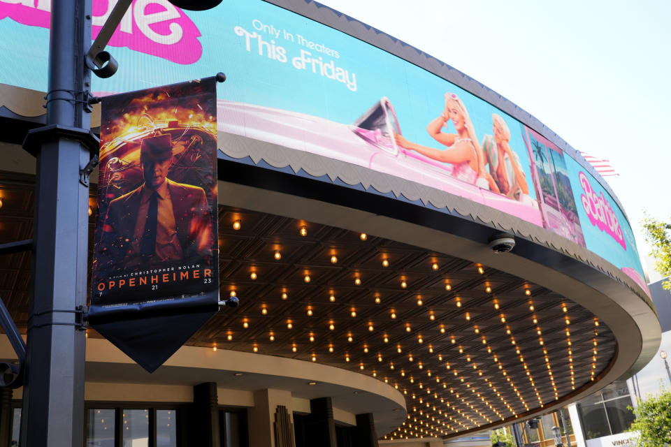 Advertisements for the films "Oppenheimer" and "Barbie" appear at AMC Theaters at The Grove on Thursday, July 20, 2023, in Los Angeles. (AP Photo/Chris Pizzello)