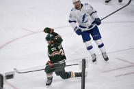 Minnesota Wild right wing Ryan Hartman, left, celebrates after scoring the go-ahead goal while skating past Tampa Bay Lightning left wing Boris Katchouk during the third period of an NHL hockey game Sunday, Nov. 28, 2021, in St. Paul, Minn. (AP Photo/Craig Lassig)