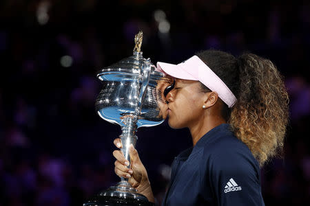 Tennis - Australian Open - Women's Singles Final - Melbourne Park, Melbourne, Australia, January 26, 2019. Japan's Naomi Osaka kisses her trophy after winning her match against Czech Republic's Petra Kvitova. REUTERS/Kim Kyung-Hoon