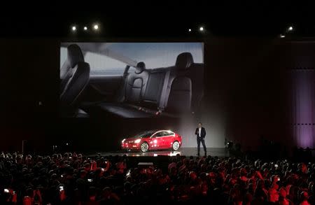 FILE PHOTO: Tesla Chief Executive Elon Musk introduces one of the first Model 3 cars off the Fremont factory's production line during an event at the company's facilities in Fremont, California, U.S. on July 28, 2017. REUTERS/Alexandria Sage/File Photo
