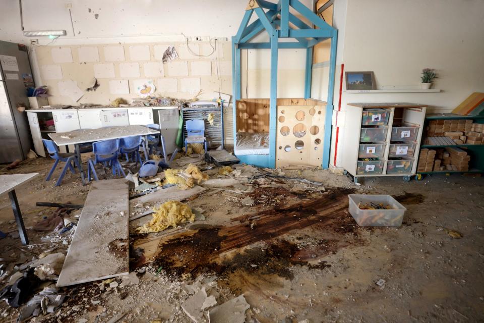 A photo of a kindergarten with dirt, debris, and blood on the floor.