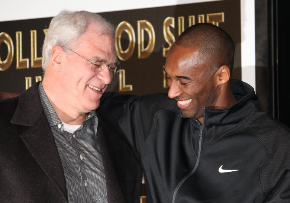 Los Angeles Lakers head coach Phil Jackson (L) and NBA player Kobe Bryant attend Bryant's hand and footprint ceremony at Grauman's Chinese Theater on Feb. 19, 2011, in Hollywood, California. (Photo: David Livingston via Getty Images)