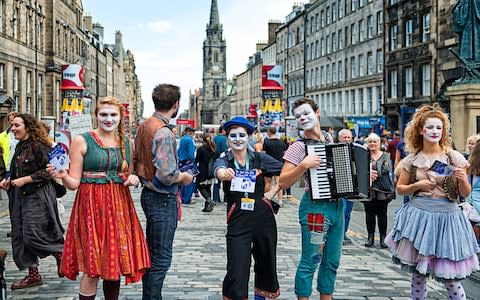 A crowd throngs the Royal Mile - Credit: Getty
