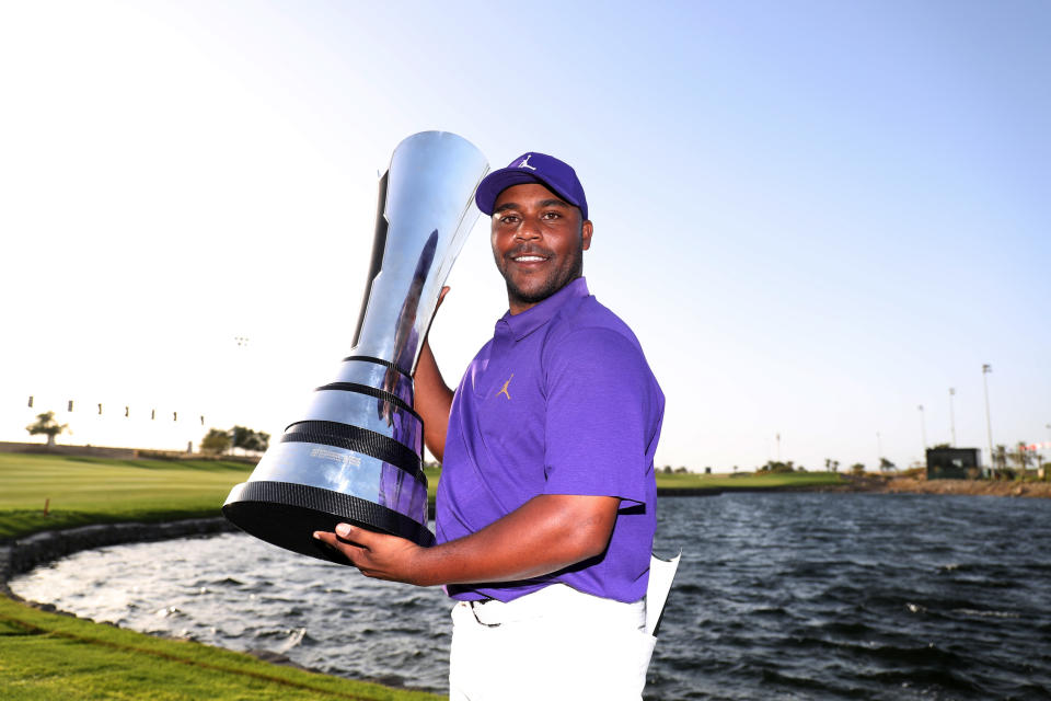 Seen here, American golfer Harold Varner III poses with his Saudi title.