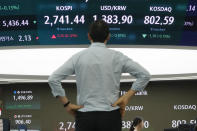 A currency trader watches the screen showing the Korea Composite Stock Price Index (KOSPI), top center left, and the foreign exchange rate between U.S. dollar and South Korean won, top center, at the foreign exchange dealing room of the KEB Hana Bank headquarters in Seoul, South Korea, Wednesday, July 31, 2024. (AP Photo/Ahn Young-joon)