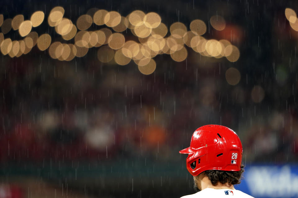 A steady rain falls as St. Louis Cardinals' Nolan Arenado stands on first base during the sixth inning of a baseball game against the Arizona Diamondbacks Thursday, April 28, 2022, in St. Louis. (AP Photo/Jeff Roberson)