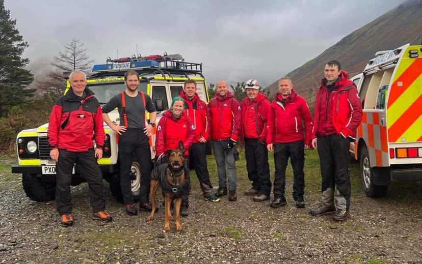 The rescuers - seen here with Dexter - look happy despite the night spent on the mountain