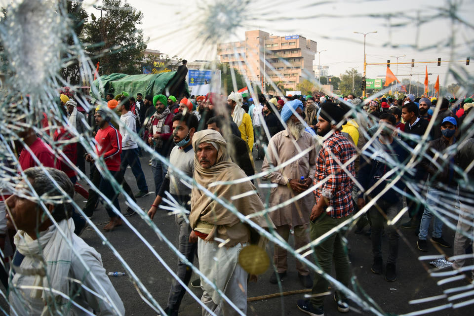 DELHI, INDIA - 2021/01/26: Protesters gathering at the ITO during the demonstration. Farmers protesting against agricultural reforms breached barricades and clashed with police in the capital on the India's 72nd Republic Day. The police fired tear gas to restrain them, shortly after a convoy of tractors trundled through the Delhi's outskirts. (Photo by Manish Rajput/SOPA Images/LightRocket via Getty Images)