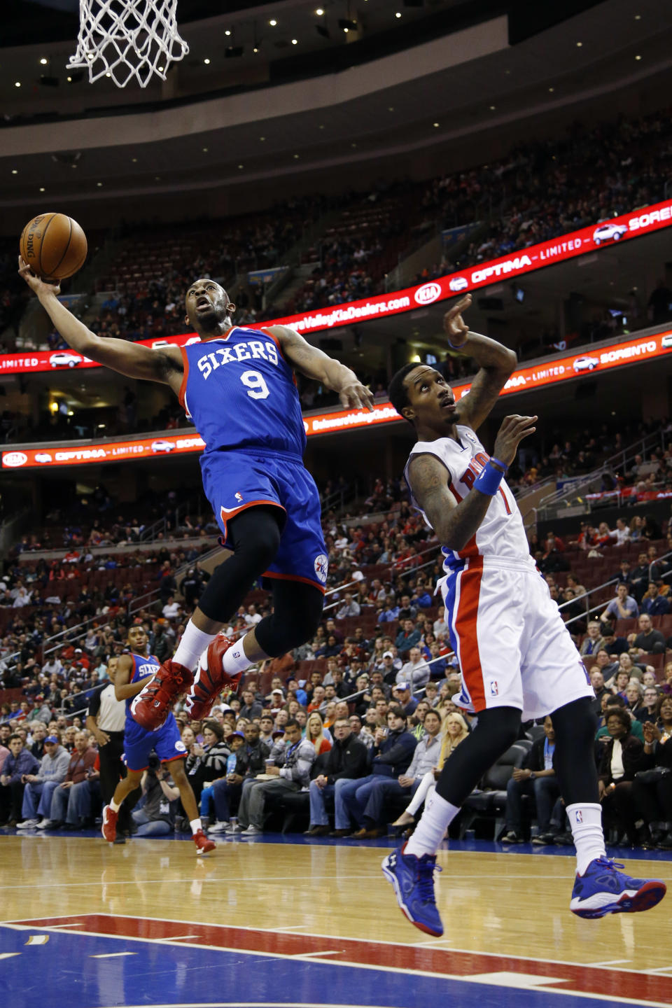 Philadelphia 76ers' James Anderson, left, goes up to shoot against Detroit Pistons' Brandon Jennings during the first half of an NBA basketball game on Saturday, March 29, 2014, in Philadelphia. (AP Photo/Matt Slocum)