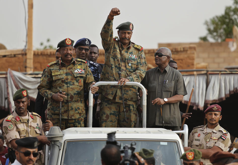 FILE - In this Saturday, June 29, 2019, file photo, Sudanese Gen. Abdel-Fattah Burhan, head of the military council, waves to his supporters upon his arrival to attend a military-backed rally in Omdurman district, west of Khartoum, Sudan. The power-sharing agreement reached between Sudan’s military and pro-democracy protesters last week came after the United States and its Arab allies applied intense pressure on both sides amid fears a prolonged crisis could tip the country into civil war, activists and officials said. (AP Photo/Hussein Malla)