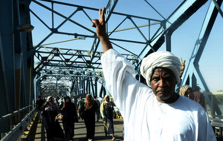 A Sudanese demonstrator gestures during a protest demanding Sudanese President Omar Al-Bashir to step down along a bridge in Khartoum, Sudan April 8, 2019. REUTERS/Stringer