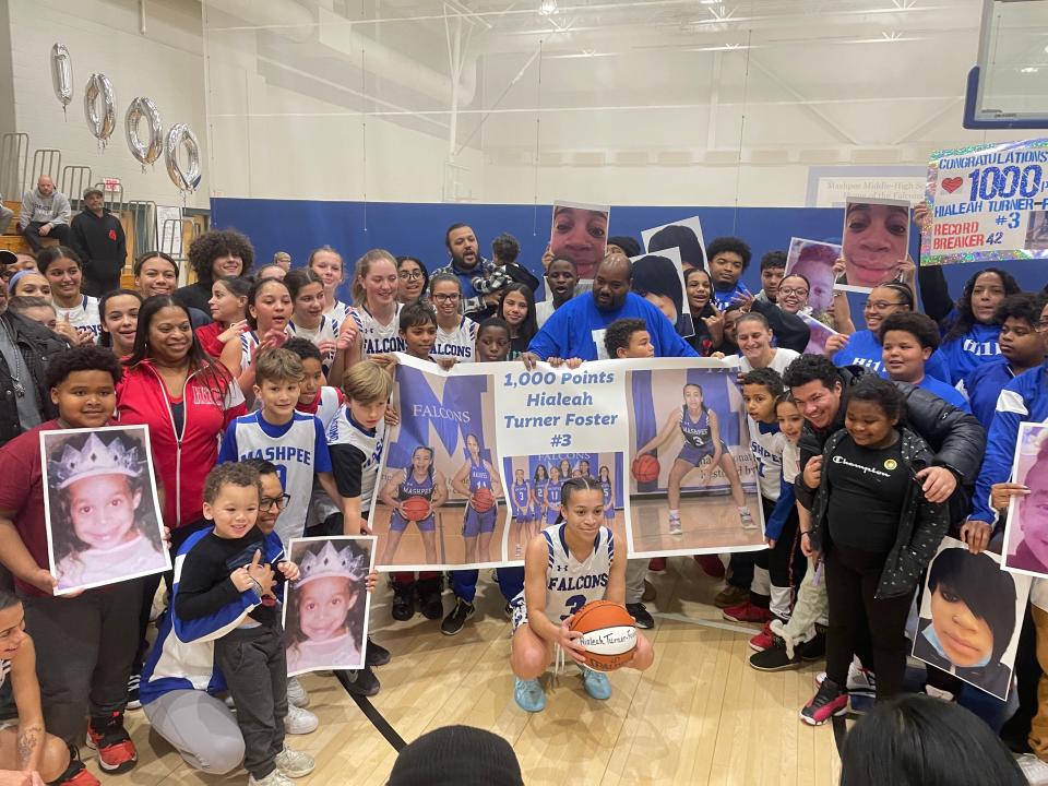 Hialeah Turner-Foster poses with family and teammates after scoring 1000th career point