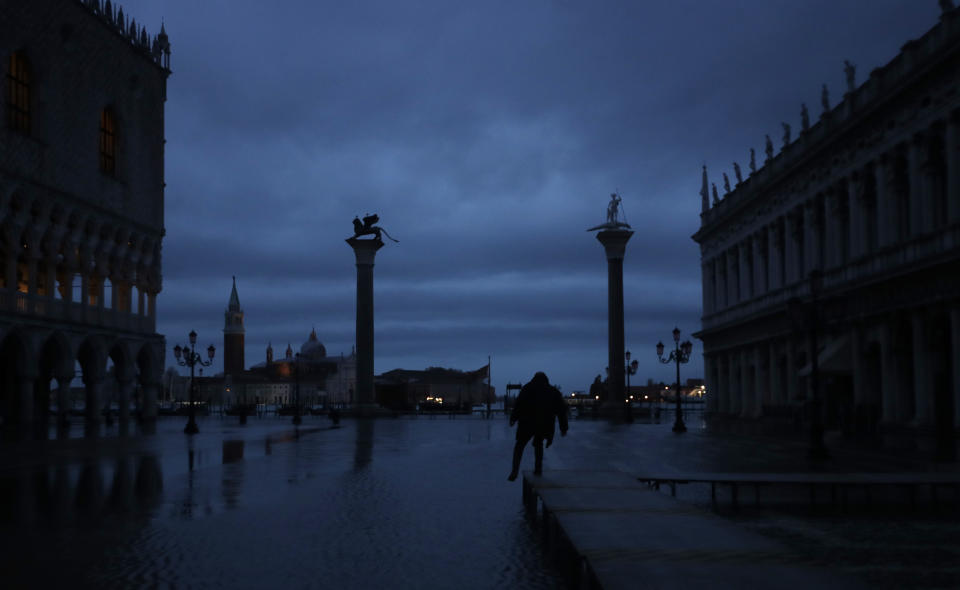 In this photo taken on Sunday, Nov.17, 2019, flood water starts coming in, in Venice, Italy, Sunday, Nov. 17, 2019. Venetians are fed up with what they see as an inadequate to the city's mounting problems: record-breaking flooding, damaging cruise ship traffic and over-tourism. They feel largely left to their own devices, and with ever fewer Venetians living in the historic part of the city to defend its interests and keep it from becoming a theme park or museum. (AP Photo/Luca Bruno)