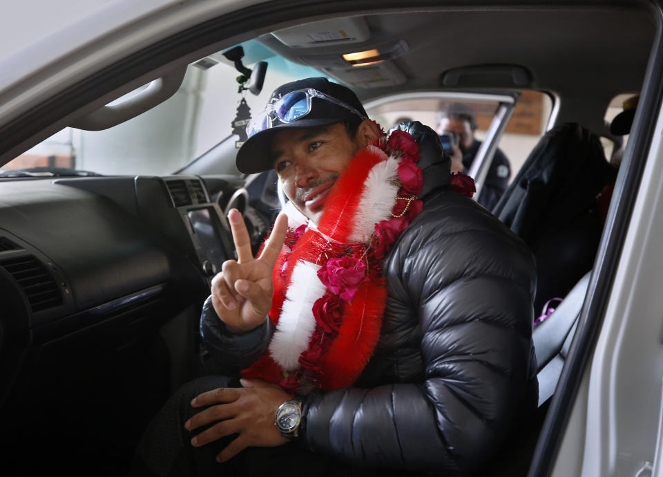 Nepalese climber Nirmal Purja, who along with his team recently made history by scaling the K2 summit in the winter season, flashes a victory sign on his arrival to the airport in Islamabad, Pakistan, Thursday, Jan. 21, 2021. Winter winds on K2 can blow at more than 200 km per hour (125 miles per hour) and temperatures can drop to minus 60 C (minus 76 F), an official of Pakistan's Alpine Club, Karrar Haideri said. (AP Photo/Anjum Naveed)