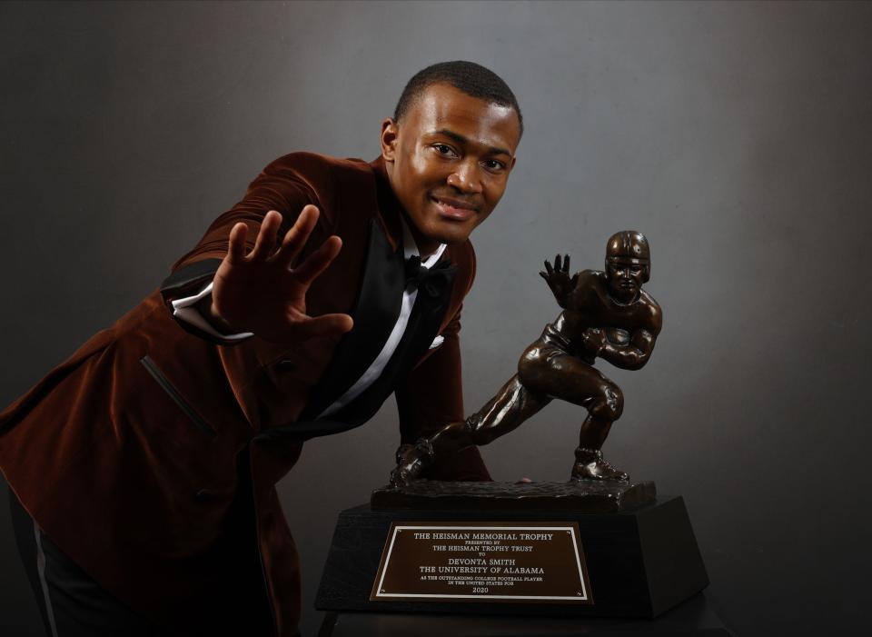 NEW YORK, NEW YORK - JANUARY 05: (EDITORIAL USE ONLY through Tuesday, January 12, 2021. Approval by the Heisman Trust will be needed for any usage thereafter or any Commercial usage requests at any point.) Wide receiver DeVonta Smith of the Alabama Crimson Tide poses with the Heisman Memorial Trophy on January 05, 2021 in New York, New York.  (Photo by Kent Gidley/Heisman Trophy Trust via Getty Images)