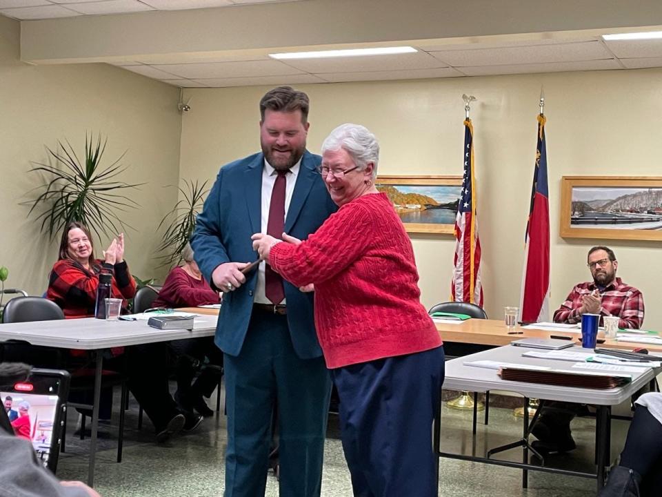 Outgoing Marshall Mayor Nancy Allen passes the town of Marshall gavel to Marshall Mayor Aaron Haynie in a symbolic gesture after Haynie was sworn in as mayor Dec. 18.