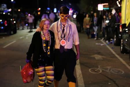 People walk away from the scene where a vehicle crashed along the Endymion parade route at Orleans and Carrollton during Mardi Gras in New Orleans, Louisiana U.S., February 25, 2017. REUTERS/Shannon Stapleton