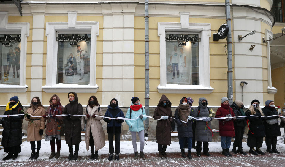 Women, some of them wearing face masks to protect against coronavirus, attend a rally in support of jailed opposition leader Alexei Navalny and his wife Yulia Navalnaya, in Moscow, Russia, Sunday, Feb. 14, 2021. (AP Photo/Alexander Zemlianichenko)