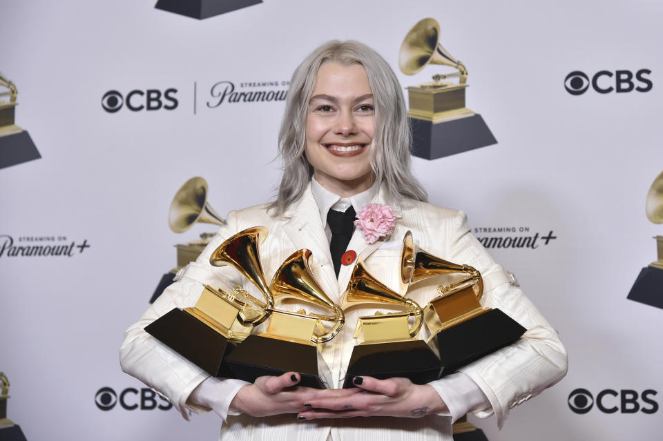 Phoebe Bridgers poses in the press room with the awards for best pop duo/group performance for "Ghost in the Machine," best rock song for "Not Strong Enough," best rock performance for "Not Strong Enough," and best alternative music album for "The Record" during the 66th annual Grammy Awards on Sunday, Feb. 4, 2024, in Los Angeles. (Photo by Richard Shotwell/Invision/AP)