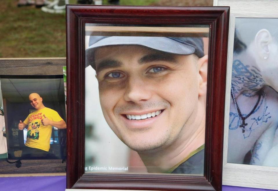 Rally goers displayed photos of loved ones on a table during a protest at the Moss Justice Center Monday.