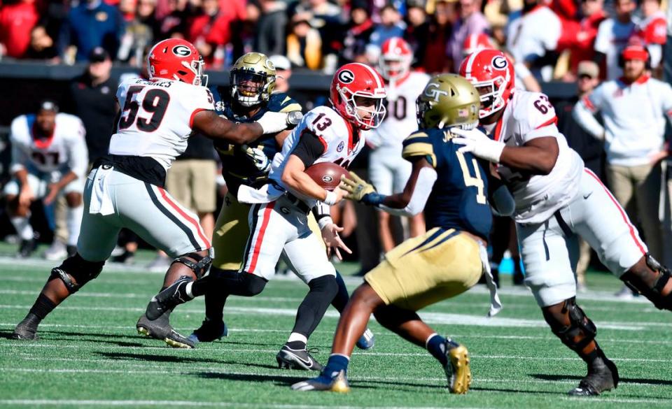 Georgia quarterback Stetson Bennett (13) rushes for a first down during the Bulldogs 45-0 win over Georgia Tech Saturday in Atlanta.