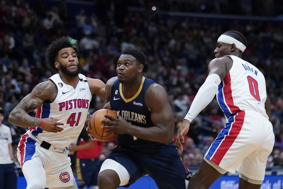 New Orleans Pelicans forward Zion Williamson (1) drives to the basket between Detroit Pistons forward Saddiq Bey (41) and center Jalen Duren (0) in the first half of an NBA basketball game in New Orleans, Wednesday, Dec. 7, 2022. (AP Photo/Gerald Herbert)
