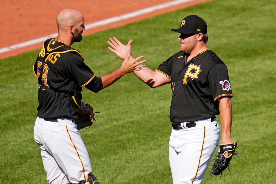 Pittsburgh Pirates relief pitcher David Bednar, right, celebrates with catcher Jacob Stallings after striking out the side in the ninth inning to preserve a win over the Detroit Tigers in a baseball game in Pittsburgh, Monday, Sept. 6, 2021. (AP Photo/Gene J. Puskar)