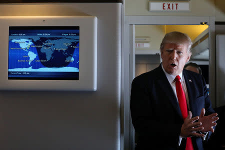 U.S. President Donald Trump talks to journalists members of the travel pool on board the Air Force One during his trip to Palm Beach, Florida while flying over South Carolina, U.S., February 3, 2017. REUTERS/Carlos Barria