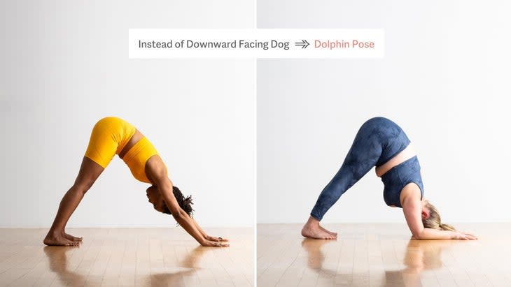 Woman in yellow yoga clothes practices Downward-Facing Dog Pose beside a woman in blue tights who is practicing Dolphin Pose