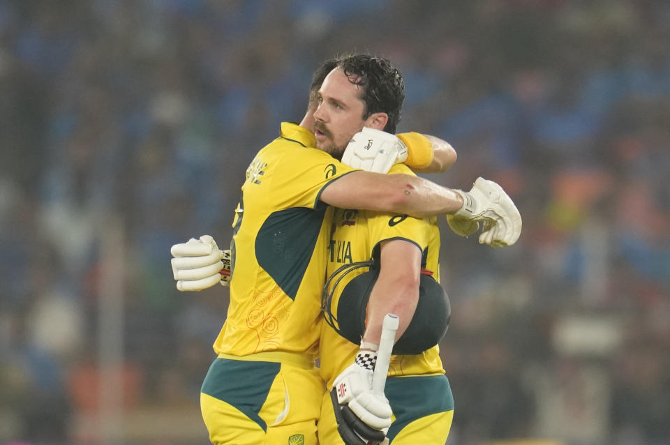 Australia's Marnus Labuschagne, left, hugs Travis Head as latter celebrates his century during the ICC Men's Cricket World Cup final match between India and Australia in Ahmedabad, India, Sunday, Nov.19, 2023. (AP Photo/Aijaz Rahi)