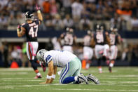 Quarterback Tony Romo #9 of the Dallas Cowboys picks himself up off the turf as Lance Briggs #55 of the Chicago Bears returns an interception of a ROmo pass 74-yards for a touchdown in the third quarter at Cowboys Stadium on October 1, 2012 in Arlington, Texas. (Photo by Ronald Martinez/Getty Images)