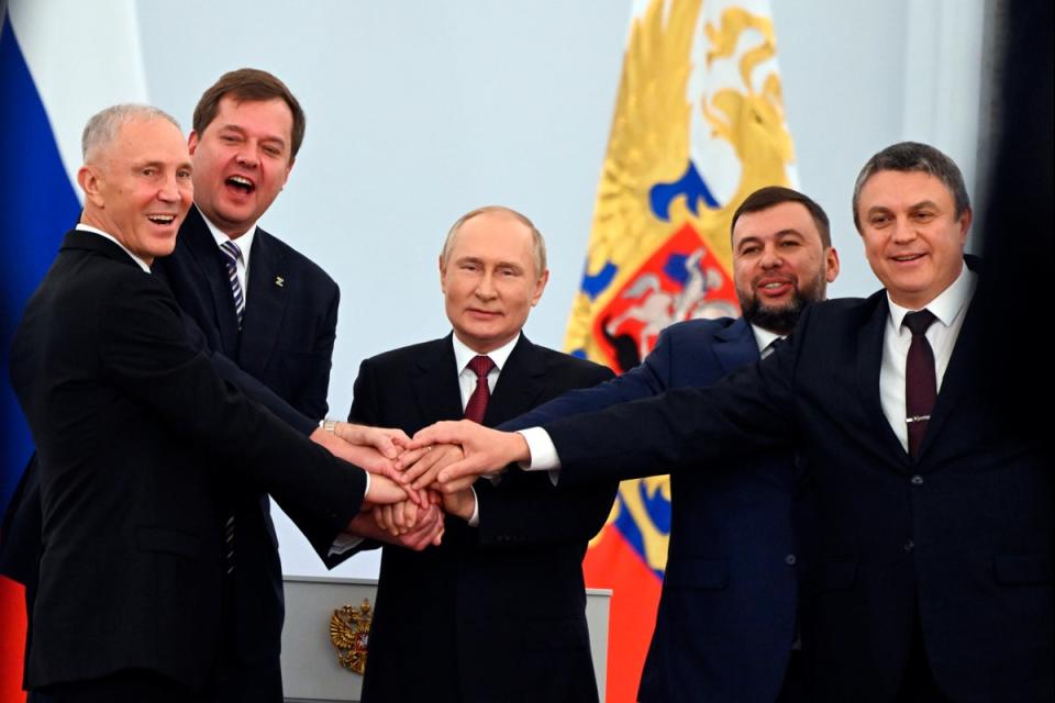 30 September 2022: From left, Moscow-appointed head of Kherson Region Vladimir Saldo, Moscow-appointed head of Zaporizhzhia region Yevgeny Balitsky, Russian President Vladimir Putin, center, Denis Pushilin, leader of self-proclaimed of the Donetsk People's Republic and Leonid Pasechnik, leader of self-proclaimed Luhansk People's Republic pose for a photo during a ceremony to sign the treaties for four regions of Ukraine to join Russia, at the Kremlin in Moscow (AP)