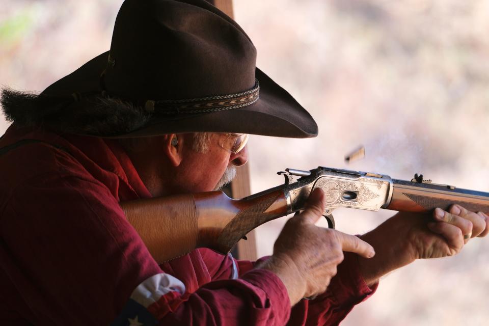 John Simpson, of Magnolia, Texas, ejects a casing Friday as he shoots his lever action rifle. The Oklahoma City Gun Club hosted the national championship of cowboy action shooting.