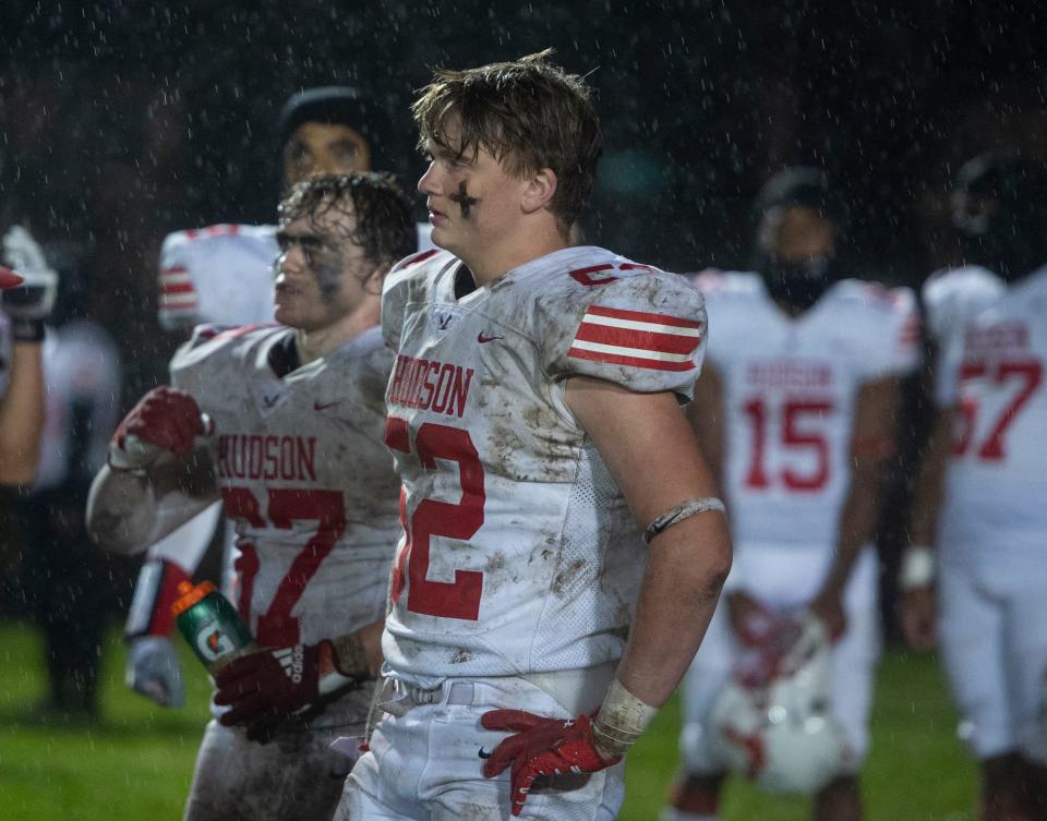 Hudson High senior Jake Clifford (left) and junior Cameron Yates listen to a coach at the half during the game at Alumni Field in Maynard, Sept. 29, 2023.