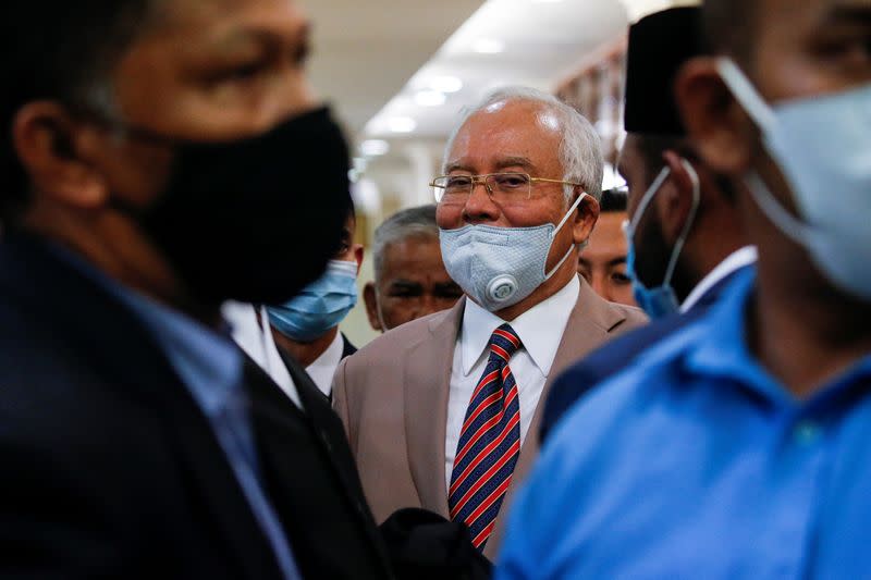 Former Malaysian Prime Minister Najib Razak reacts before leaving Kuala Lumpur High Court in Kuala Lumpur