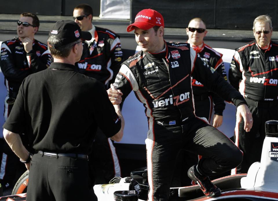 Will Power, center, of Australia, shakes hands with crew members after winning the IndyCar Grand Prix of St. Petersburg auto race Sunday, March 30, 2014, in St. Petersburg, Fla. (AP Photo/Chris O'Meara)