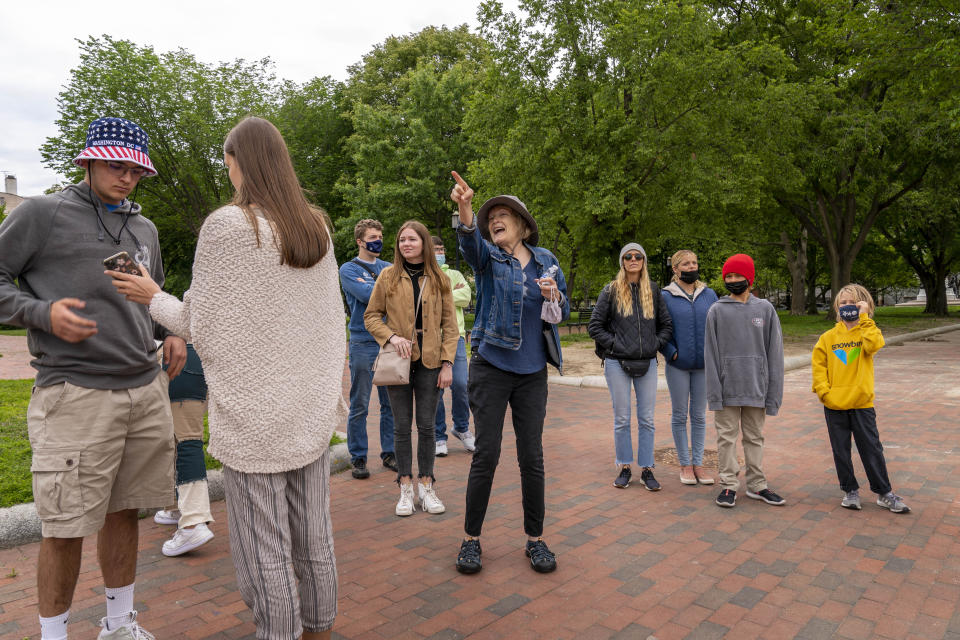 Charity Struthers with Signature Tours brings a group of students into Lafayette Park, across the street from the White House, as it reopens in a limited capacity in Washington, Monday, May 10, 2021. Fencing remains in place around the park which will allow the Secret Service to temporarily close the park as they deem necessary. (AP Photo/Andrew Harnik)