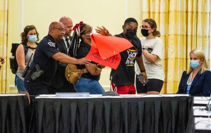Demonstrators are removed from a closed session meeting of the UNC-Chapel Hill trustees Wednesday, June, 30, 2021 as they prepared to discuss and vote on tenure for distinguished journalist Nikole Hannah-Jones.