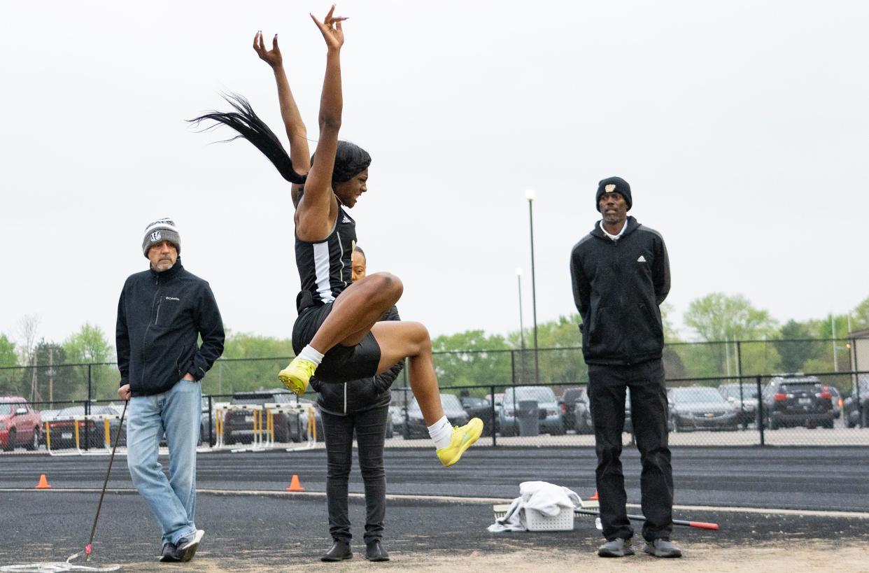 Warren Central's Jila Vaden jumps the long jump Friday, April 28, 2023, at Warren Central High School in Indianapolis during the Metropolitan Interscholastic Conference track meet.
