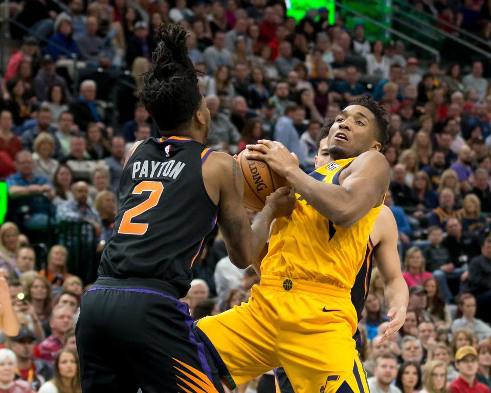 Feb 14, 2018; Salt Lake City, UT, USA; Phoenix Suns guard Elfrid Payton (2) ties up Utah Jazz guard Donovan Mitchell (45) for a jump ball during the first half at Vivint Smart Home Arena.