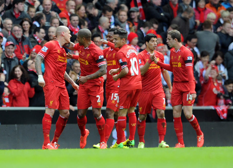 Liverpool's Martin Skrtel left, celebrates with his team-mates after he scores the second goal of the game for his side during their English Premier League soccer match against Manchester City at Anfield in Liverpool, England, Sunday April. 13, 2014. (AP Photo/Clint Hughes)